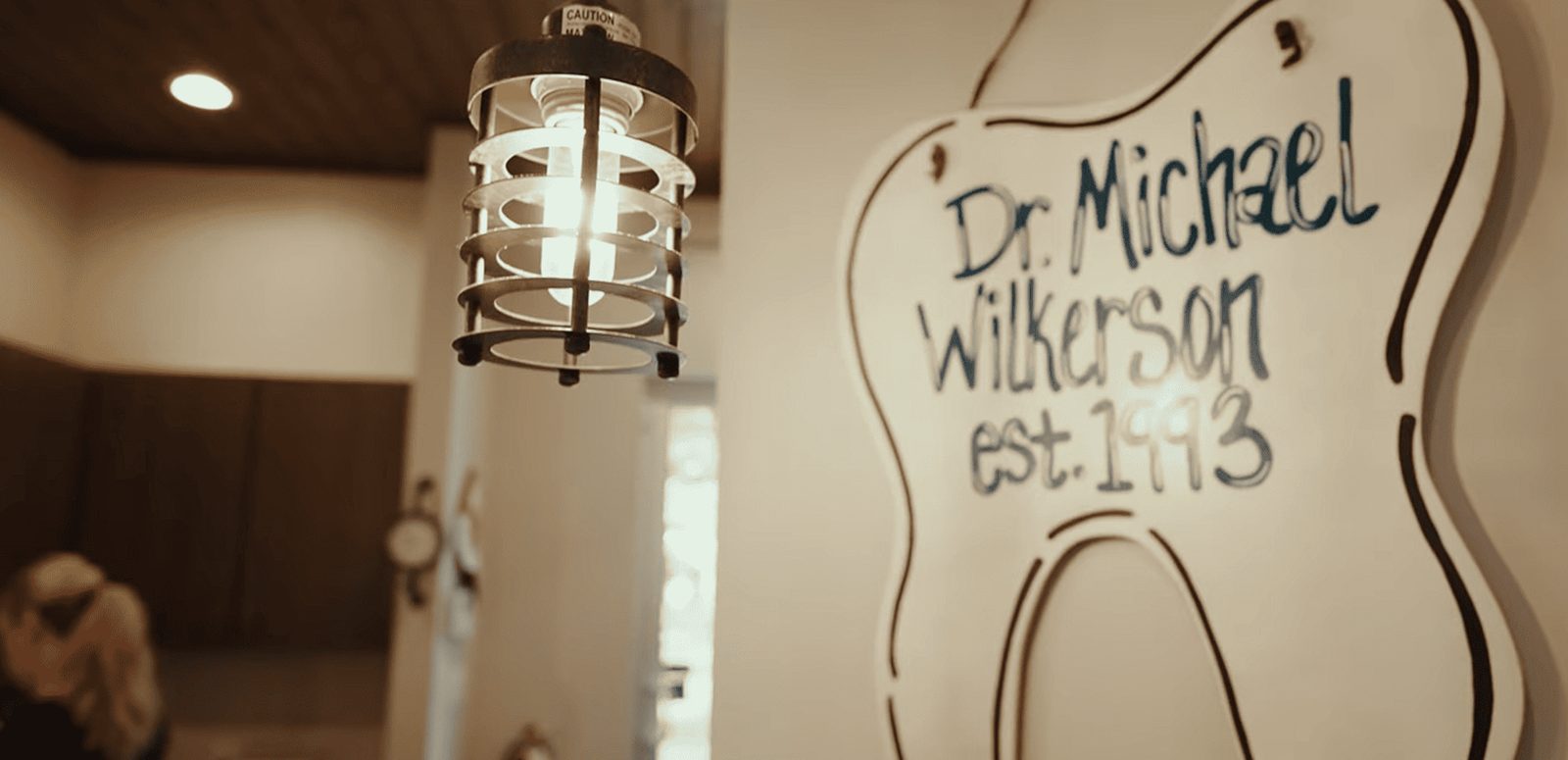 Tooth-shaped sign reading Dr. Michael Wilkerson, est. 1993, inside The Kid’s Place in Boerne, TX