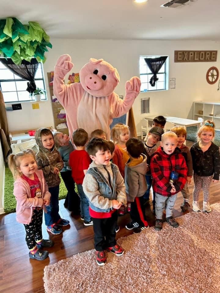 The Kid's Place pig mascot visiting a preschool class